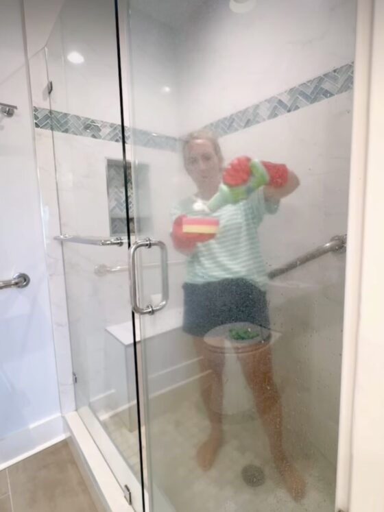 How to Clean Glass Shower Doors - Put on your gloves and generously apply the cleaner to the glass. Let it sit for 5–10 minutes to break down the grime.