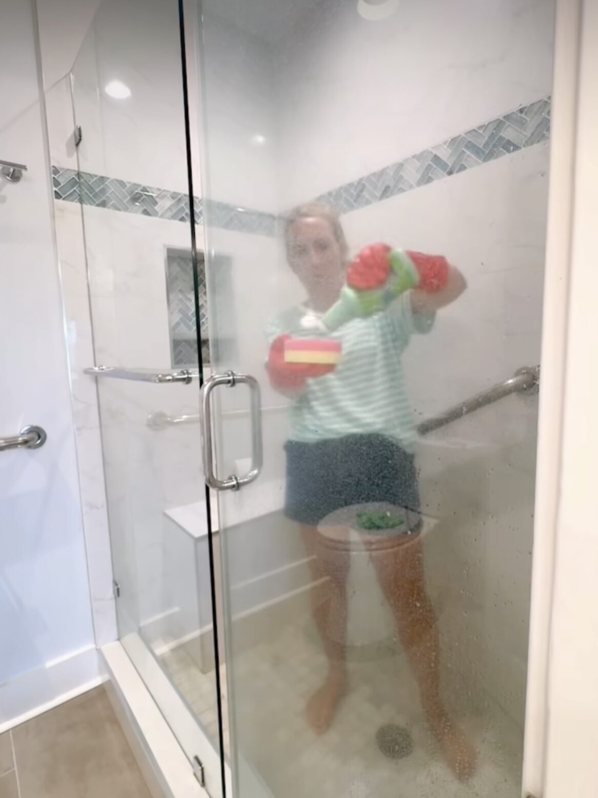 How to Clean Glass Shower Doors - Put on your gloves and generously apply the cleaner to the glass. Let it sit for 5–10 minutes to break down the grime.